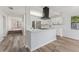 Spacious kitchen featuring a center island, stainless steel appliances, and wood-look flooring at 4410 19Th N St, St Petersburg, FL 33714