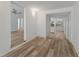 Open-concept layout featuring wood-look flooring and white walls with views to other rooms at 4410 19Th N St, St Petersburg, FL 33714