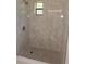 Walk-in shower with modern tilework and a hexagon-tiled floor at 4410 19Th N St, St Petersburg, FL 33714