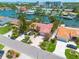 Waterfront home featuring a red tile roof, lush landscaping, and boat dock access to the tranquil canal at 4490 38Th S Way, St Petersburg, FL 33711