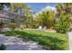 Secluded backyard with a lush lawn, patio area, and view of the screened-in pool at 4490 38Th S Way, St Petersburg, FL 33711