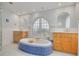 A spa-like bathroom with an oval tub, blue accents, and separate and vanities at 4490 38Th S Way, St Petersburg, FL 33711