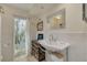 Bright bathroom featuring a unique vanity, textured walls, and natural light through a window at 4490 38Th S Way, St Petersburg, FL 33711