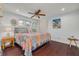 Cozy bedroom features hardwood floors, a decorative ceiling fan, and bright, colorful decor at 4490 38Th S Way, St Petersburg, FL 33711