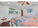 Bedroom with dark wood floors and colorful bedding at 4490 38Th S Way, St Petersburg, FL 33711