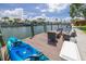 Enjoy the waterfront lifestyle on this wooden dock featuring a sitting area and kayak at 4490 38Th S Way, St Petersburg, FL 33711