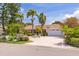 Charming single-story home with a manicured lawn, mature palm trees, brick paved drive, and a two-car garage at 4490 38Th S Way, St Petersburg, FL 33711