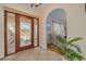 Inviting foyer features decorative glass entry doors, tile flooring, and an archway leading to the living area at 4490 38Th S Way, St Petersburg, FL 33711