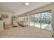 Bright living room featuring tile floors, ample seating, fireplace, and a view of an outdoor pool area at 4490 38Th S Way, St Petersburg, FL 33711