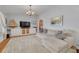 Comfortable living room features built-in storage and a large sectional sofa at 4490 38Th S Way, St Petersburg, FL 33711