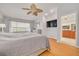 Bright main bedroom featuring wood floors, ceiling fan, and ensuite bathroom access at 4490 38Th S Way, St Petersburg, FL 33711