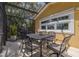 Outdoor dining area with ornate metal table and chairs in a screened-in lanai at 4490 38Th S Way, St Petersburg, FL 33711
