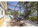 Outdoor dining area with ornate metal table and chairs with views of the pool and canal at 4490 38Th S Way, St Petersburg, FL 33711