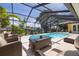 Screened-in pool area with lounge seating and views of the canal at 4490 38Th S Way, St Petersburg, FL 33711