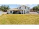 Spacious backyard featuring a well-maintained lawn and a covered patio, perfect for outdoor entertaining at 4809 Walnut Ridge Rd, Land O Lakes, FL 34638