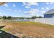 Backyard overlooking the pond with a white picket fence at 4809 Walnut Ridge Rd, Land O Lakes, FL 34638