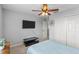 Bedroom featuring ceiling fan, closet, TV, and side table at 4809 Walnut Ridge Rd, Land O Lakes, FL 34638