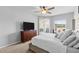 Light-filled bedroom with plush bed, ceiling fan, dresser with TV and sliding door to the lanai at 4809 Walnut Ridge Rd, Land O Lakes, FL 34638