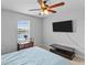 Bedroom featuring ceiling fan, TV, view of the pond, and side table at 4809 Walnut Ridge Rd, Land O Lakes, FL 34638