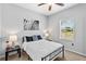 Bedroom features a queen sized bed, ceiling fan, and natural light at 4809 Walnut Ridge Rd, Land O Lakes, FL 34638