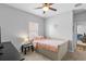 Comfortable bedroom features plush bedding, a ceiling fan, and a large window at 4809 Walnut Ridge Rd, Land O Lakes, FL 34638