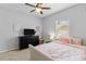 Comfortable bedroom features plush bedding, a ceiling fan, and a large window at 4809 Walnut Ridge Rd, Land O Lakes, FL 34638