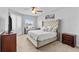 Bright bedroom featuring a tufted headboard, ceiling fan, and a window with views at 4809 Walnut Ridge Rd, Land O Lakes, FL 34638