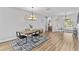 Inviting dining room with modern light fixture and stylish table set for four at 4809 Walnut Ridge Rd, Land O Lakes, FL 34638