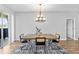 Formal dining room with stylish chandelier and an accent rug that complements the natural light and neutral tones at 4809 Walnut Ridge Rd, Land O Lakes, FL 34638