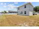 Rear exterior view of home showcasing the backyard and a pristine white fence ensuring privacy and charm at 4809 Walnut Ridge Rd, Land O Lakes, FL 34638