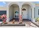 Home's welcoming front entrance with arched entryways and well maintained landscaping at 4809 Walnut Ridge Rd, Land O Lakes, FL 34638