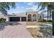 Charming home featuring a spacious three car garage and a brick paved driveway at 4809 Walnut Ridge Rd, Land O Lakes, FL 34638