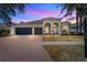 Charming home featuring a spacious three car garage and a brick paved driveway at 4809 Walnut Ridge Rd, Land O Lakes, FL 34638