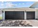 Spacious garage with large garage doors and outdoor lighting at 4809 Walnut Ridge Rd, Land O Lakes, FL 34638