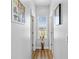 Bright hallway with wood flooring and a window at the end of the hall at 4809 Walnut Ridge Rd, Land O Lakes, FL 34638