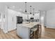Bright kitchen features white cabinetry, stainless steel appliances, a large marble island with seating, and wood-look flooring at 4809 Walnut Ridge Rd, Land O Lakes, FL 34638