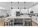 Bright kitchen with stainless steel appliances, gray tile backsplash, a large island with seating, and hardwood floors at 4809 Walnut Ridge Rd, Land O Lakes, FL 34638