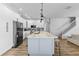 Bright kitchen with stainless steel appliances, center island with marble countertop, and wood flooring at 4809 Walnut Ridge Rd, Land O Lakes, FL 34638