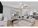 Open concept living room with a large sectional, ceiling fan, and lots of natural light at 4809 Walnut Ridge Rd, Land O Lakes, FL 34638