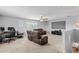 Spacious living room with ceiling fan, media center, and comfortable brown leather seating at 4809 Walnut Ridge Rd, Land O Lakes, FL 34638