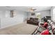 Open living room with ceiling fan, comfortable brown leather seating, and neutral carpeting at 4809 Walnut Ridge Rd, Land O Lakes, FL 34638