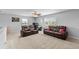 Neutral living room features two windows, comfortable brown leather seating, and neutral carpeting at 4809 Walnut Ridge Rd, Land O Lakes, FL 34638