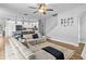 Open concept living room with a large sectional that flows into the kitchen at 4809 Walnut Ridge Rd, Land O Lakes, FL 34638