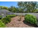 Private backyard featuring a white fence and mature landscaping, perfect for outdoor enjoyment at 4868 Lake Valencia E Blvd, Palm Harbor, FL 34684