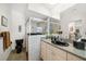 Well-lit bathroom with a glass-enclosed shower and a granite countertop vanity at 4868 Lake Valencia E Blvd, Palm Harbor, FL 34684