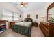 Bright bedroom with a ceiling fan, earth tone color scheme, and comfortable furnishings at 4868 Lake Valencia E Blvd, Palm Harbor, FL 34684