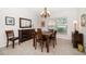 Cozy dining room with wood table, chandelier, and a window with natural light at 4868 Lake Valencia E Blvd, Palm Harbor, FL 34684