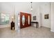 Bright foyer with tiled floor, double doors, console table and high ceiling at 4868 Lake Valencia E Blvd, Palm Harbor, FL 34684