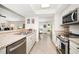 Well-equipped kitchen featuring stainless steel appliances, granite countertops, and neutral cabinetry at 4868 Lake Valencia E Blvd, Palm Harbor, FL 34684