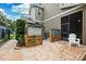 Backyard patio with privacy screen, chairs, brick pavers, and access to screened-in patio at 5949 Parkset Dr, Lithia, FL 33547